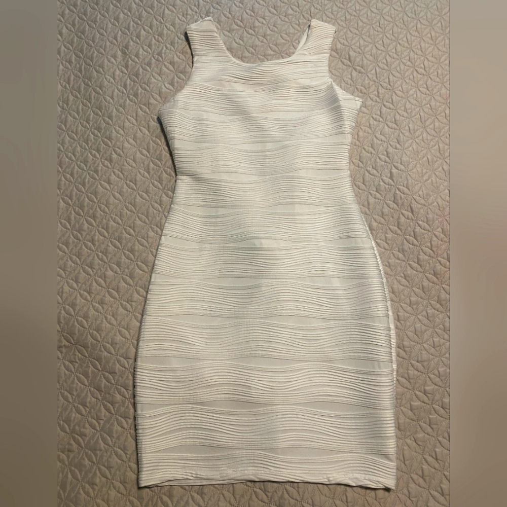 White fitting dress, made of spandex and poly blend.
